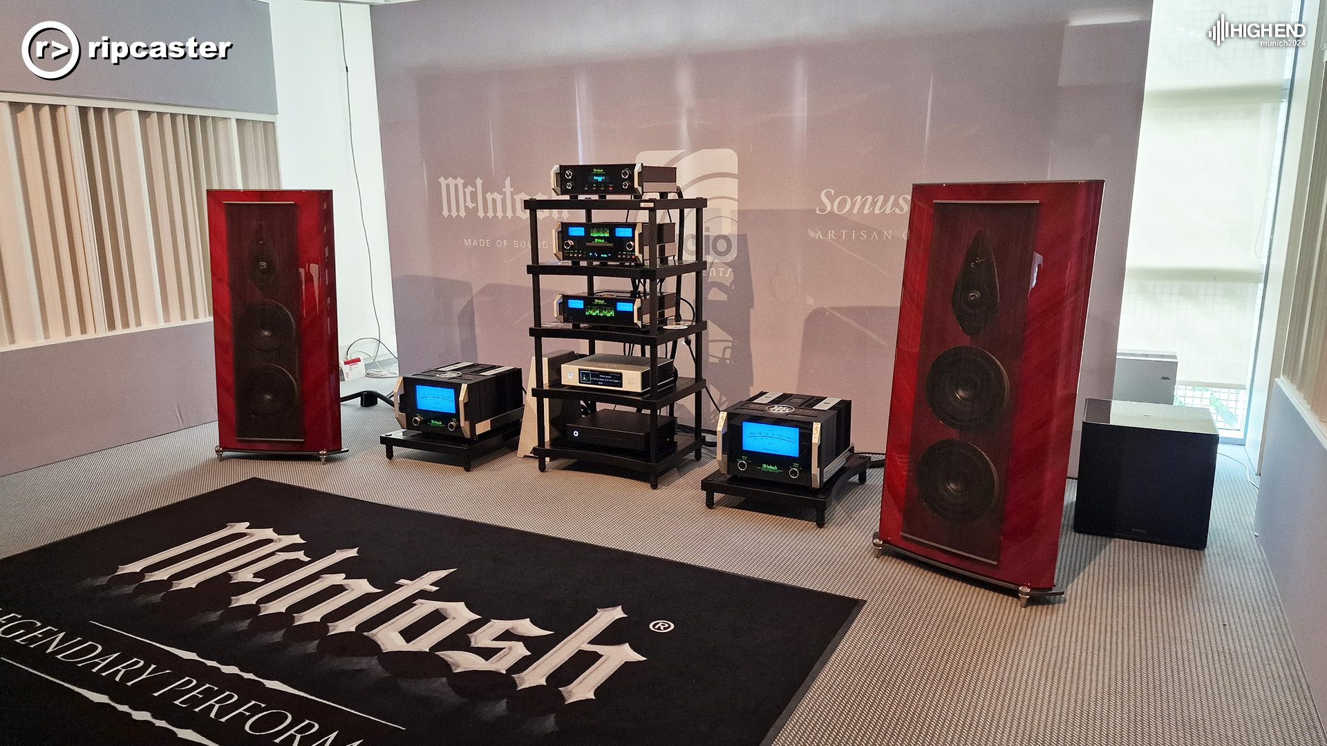 McIntosh.  A pair of floorstanding red speakers either side of a rack of HiFi equipment