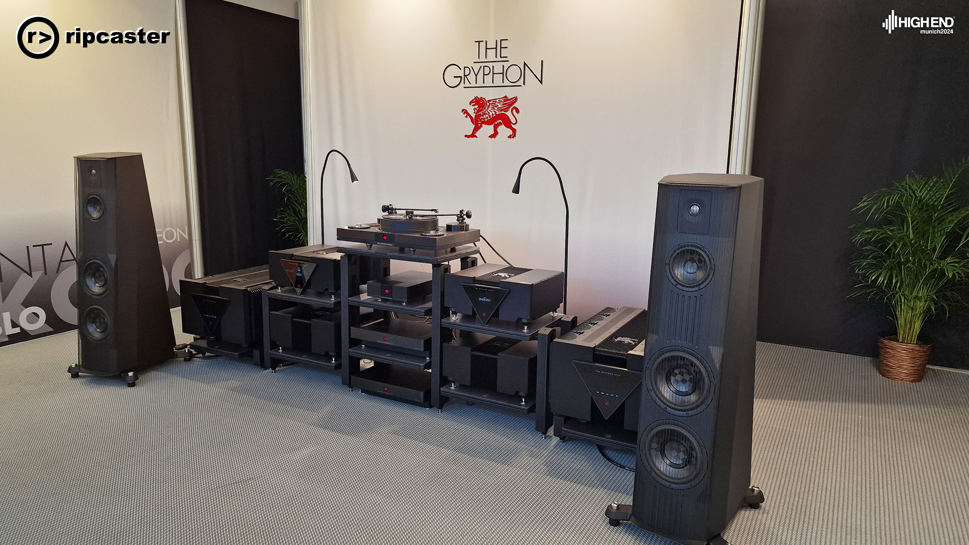 The Gryphon.  A pair of black floorstanding speakers either side of various pieces of HiFi equipment.