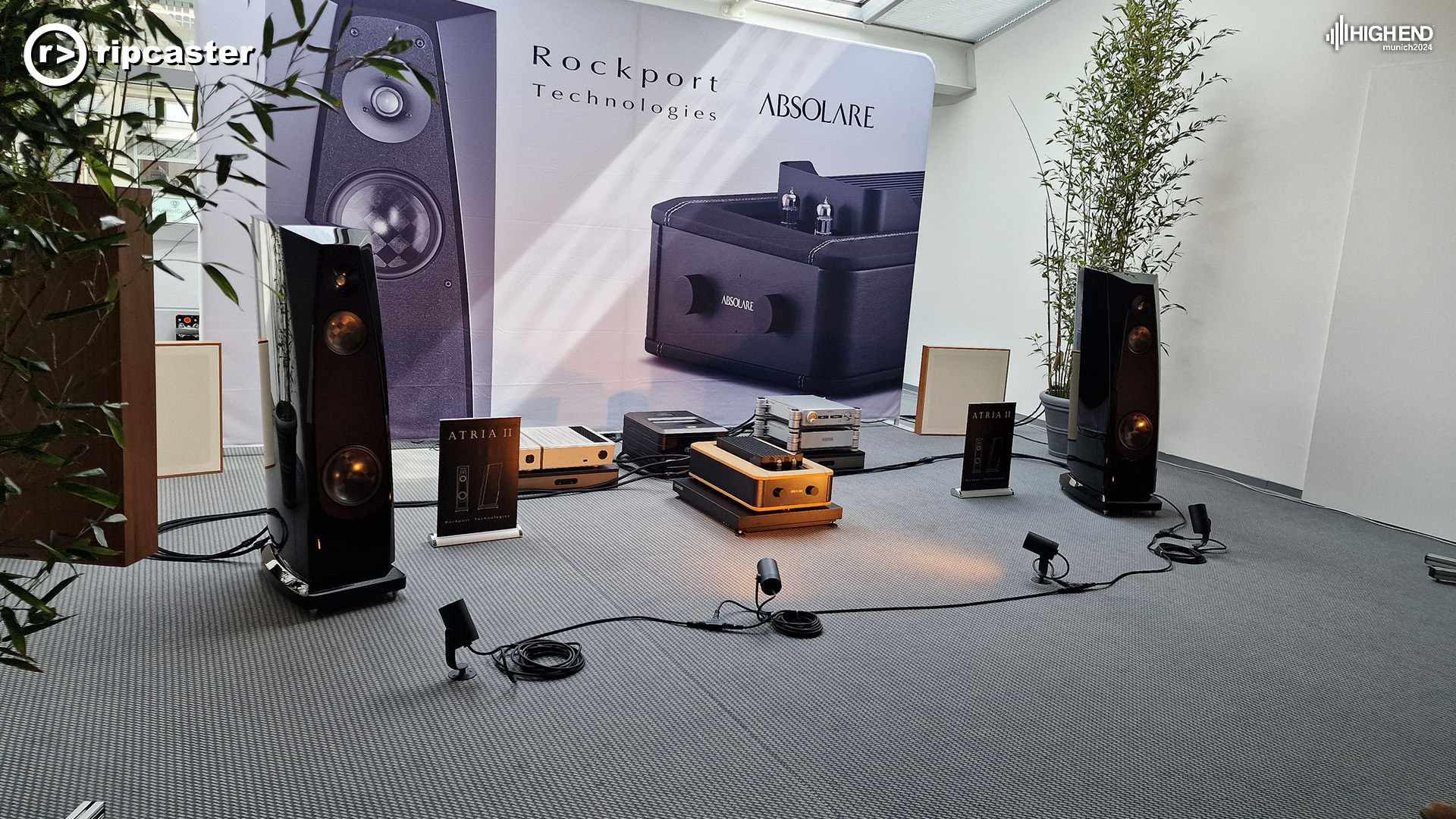 Absolare.  A pair of black floorstanding speakers with HiFi  equipment between