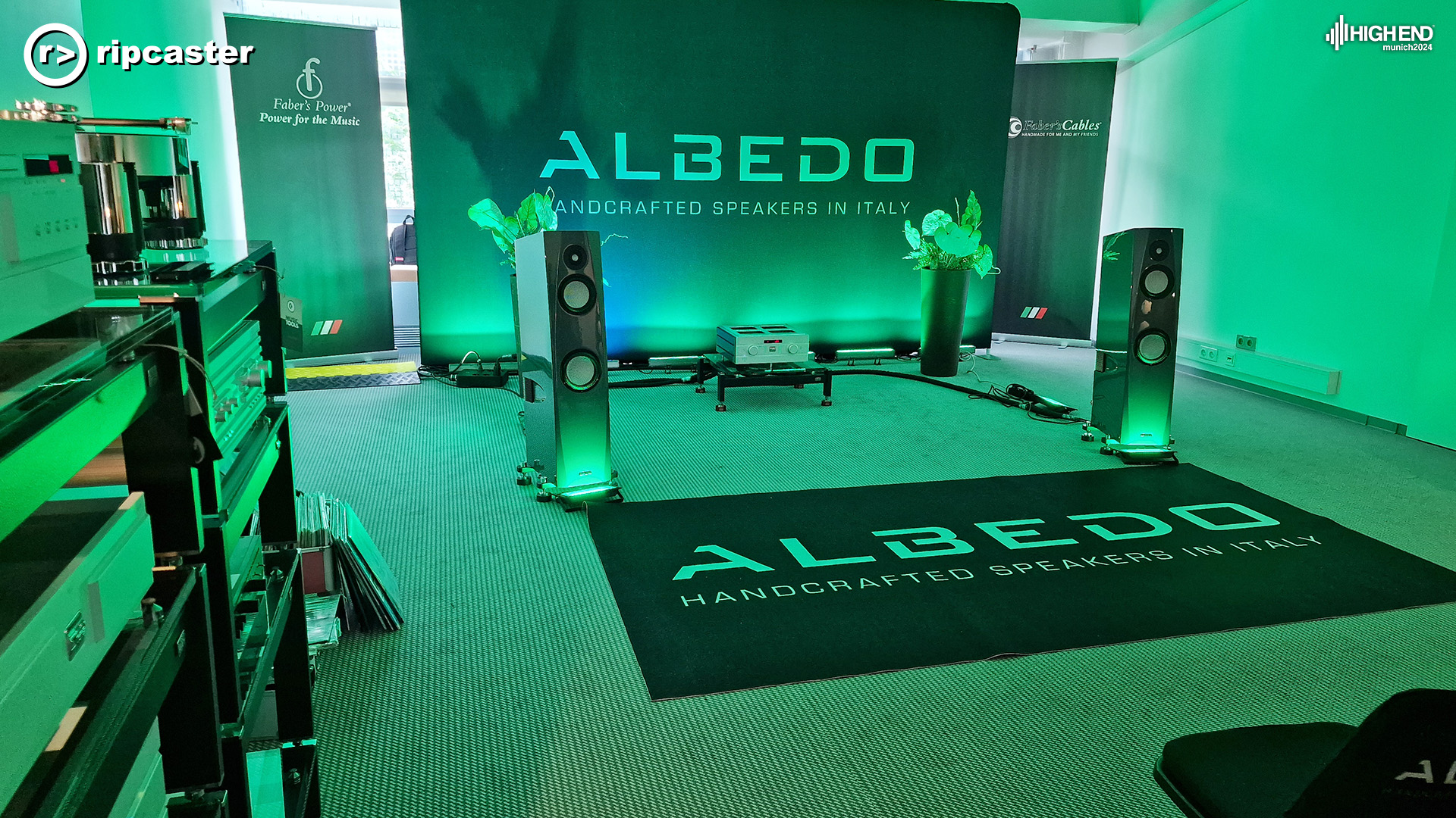 Albedo.  A pair of floorstanding speakers with other HiFi equipment between them and to the side in the foreground.