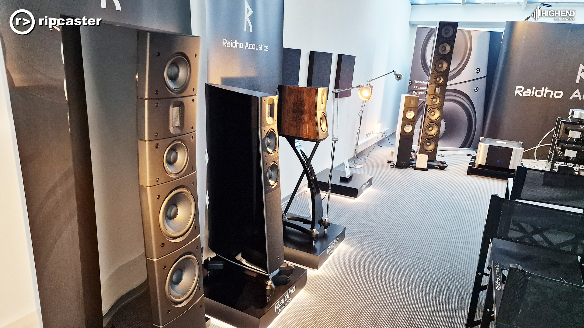 Raidho speakers lined up along a side wall.  The large speakers from the image above and their small friend the white speaker are in the background.  MOON equipment can also be seen here at the back of the picture.