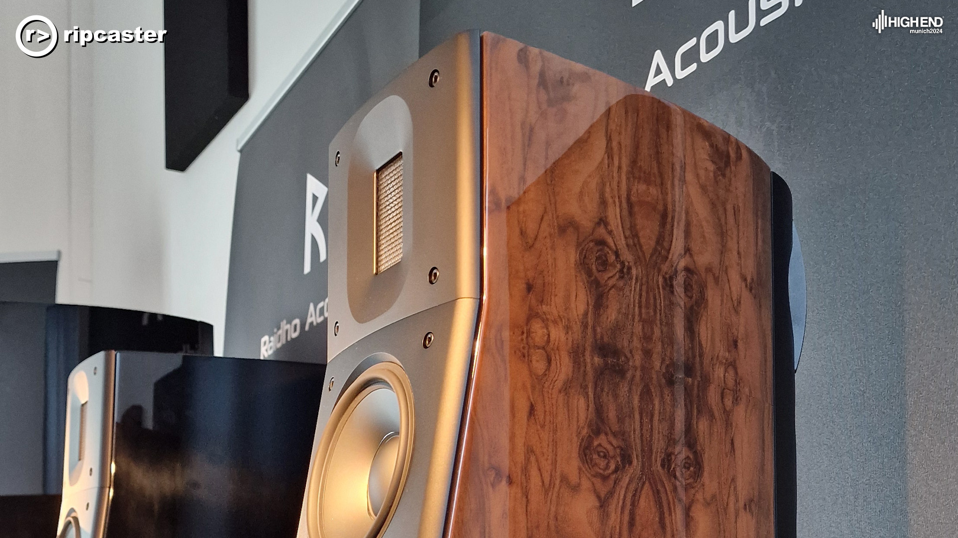 A close-up of a Raidho speaker showing the burl finish nicely.  The front of it has a gold tinge to it.