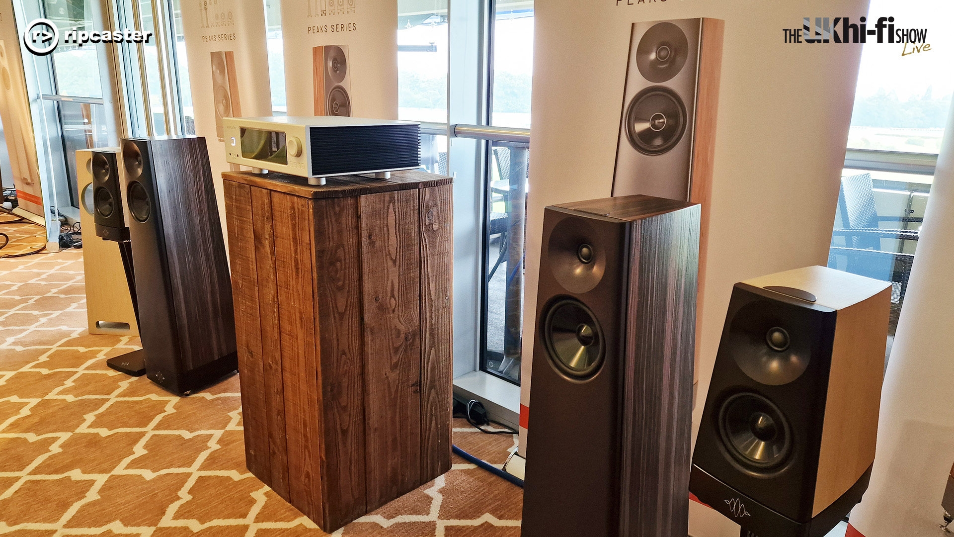 A selection of speakers side by side with a HiFi unit between them.