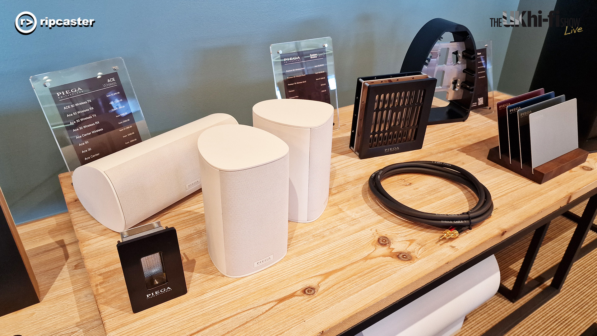 A selection of speakers on a wooden table