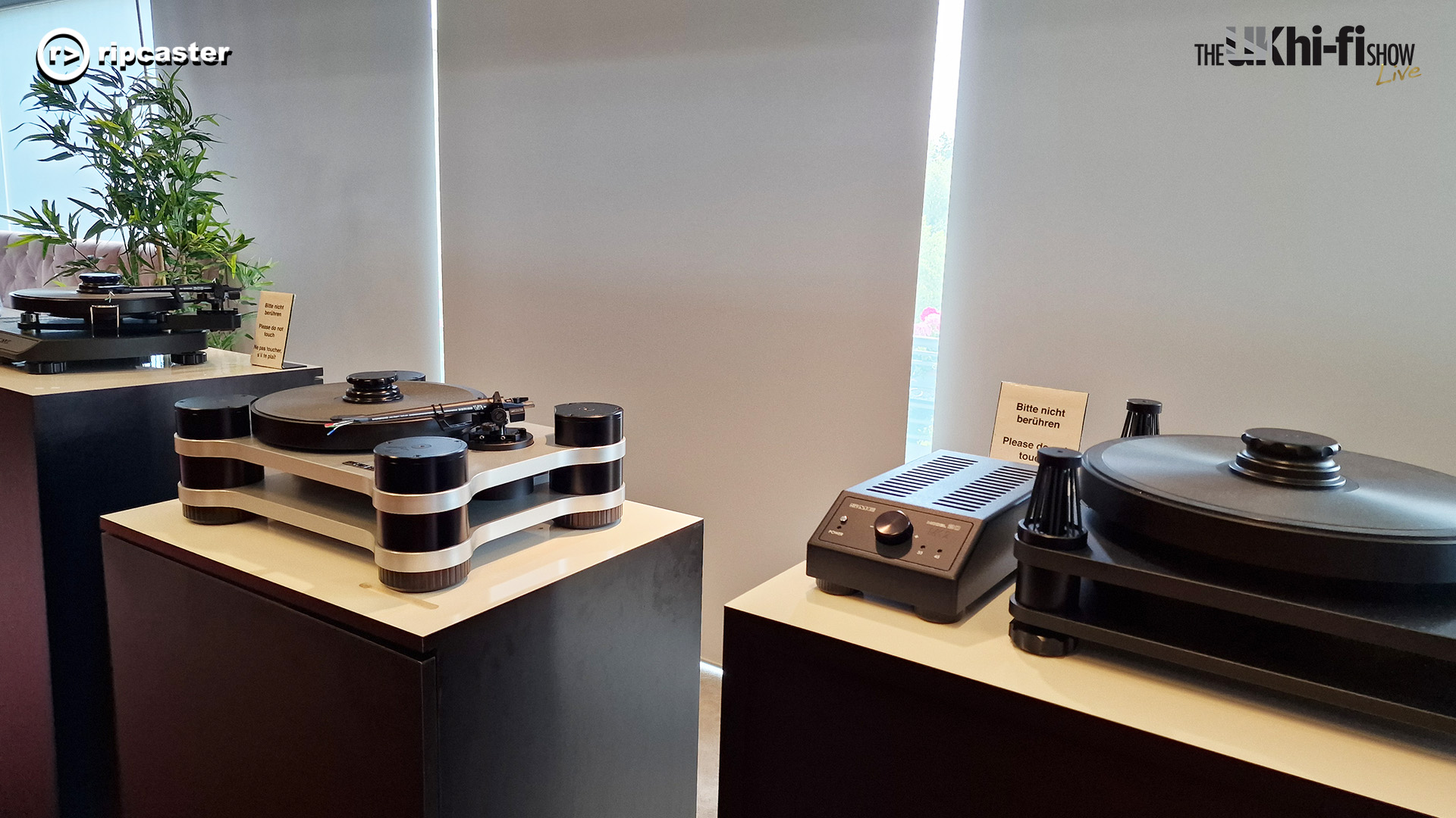 Three turntables each on a wooden plinth