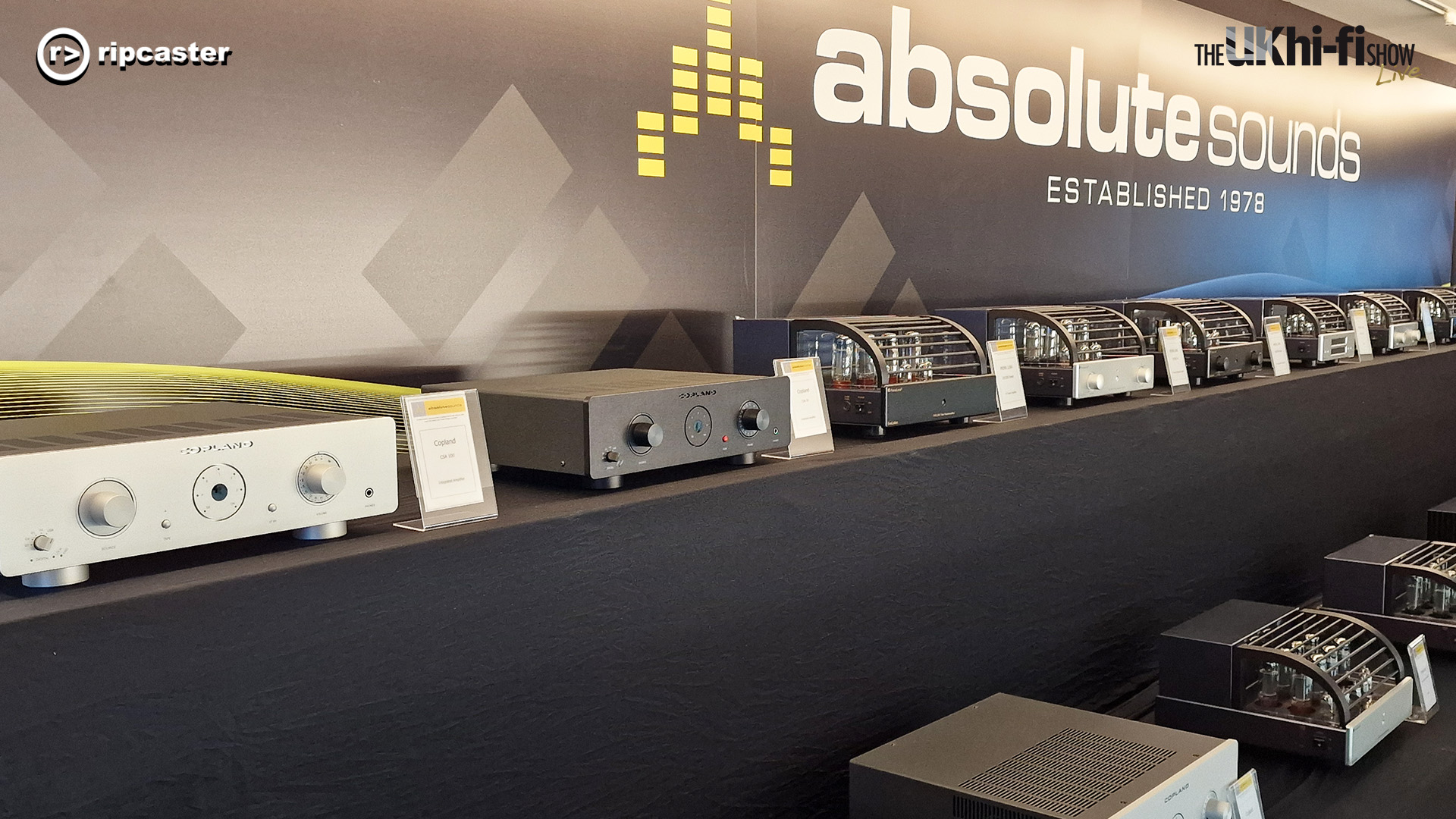 Absolute sounds.  A selelction of HiFi equipment, mostly tube amplifiers, lined up on a long black table