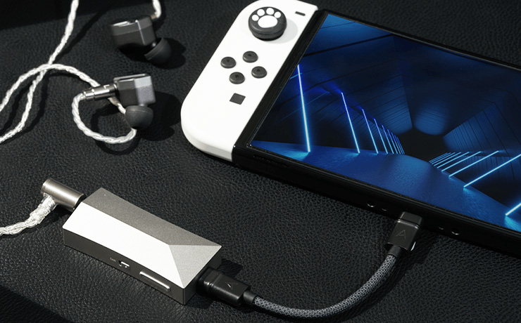 Astell & Kern AK HC4 on a table plugged into a Nintendo Switch with earphones close by