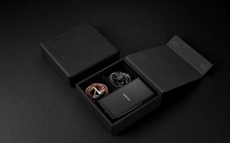 The case on a dark table with two pairs of earphones in the case