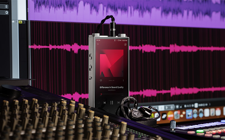 Astell & Kern PD20 Portable Music Player standing up beside a mixing desk