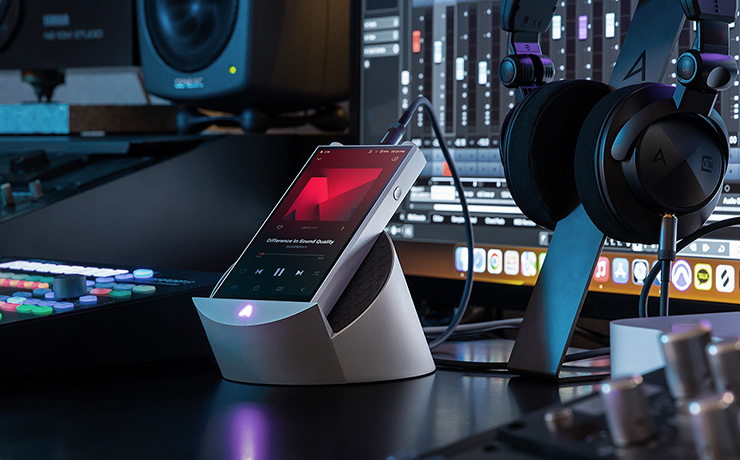 The Astell & Kern PD20 on a stand with headphones beside them