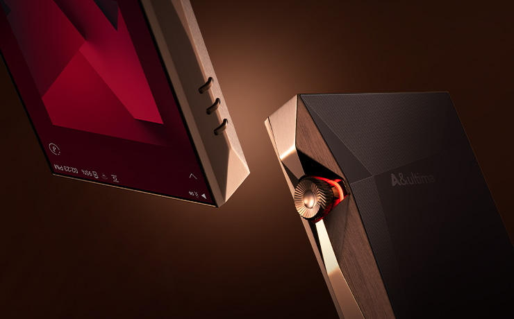 an arty image of two copper A&K SP4000 players.  Both at an angle on a dark background.  One angled so the back is visible, the other upside down and front visible