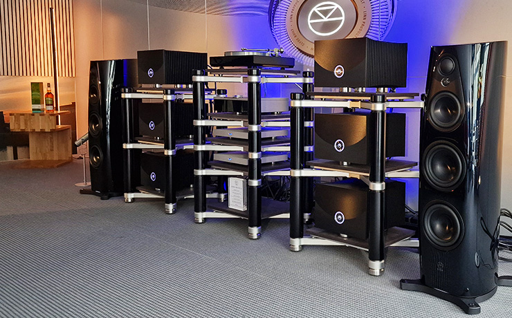 The Linn 360 speakers in black with a range of other Linn HiFi equipment between them.  The image was taken at the 2024 HiFi Munich show