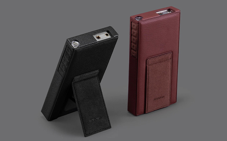 A pair of Astell & Kern PD10 cases. Both with the PD10 inside - one in black and one in brown