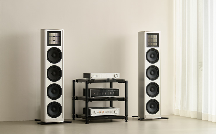 HiFi Rose RD160 in silver on a HiFi stand with a floorstanding speaker either side