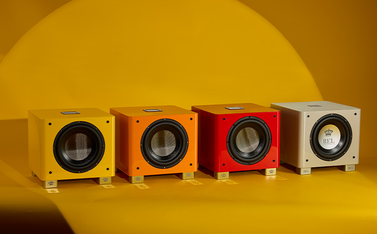 Four Rel subs lined up next to each other on a yellow background.  they are, left to right yellow, orange, red and silver