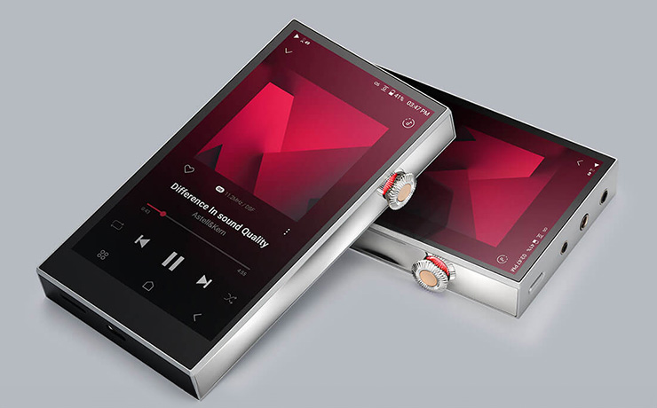 A pair of Astell & Kern SE300 Portable Music Players laying face up.  One is laying partly on the other.