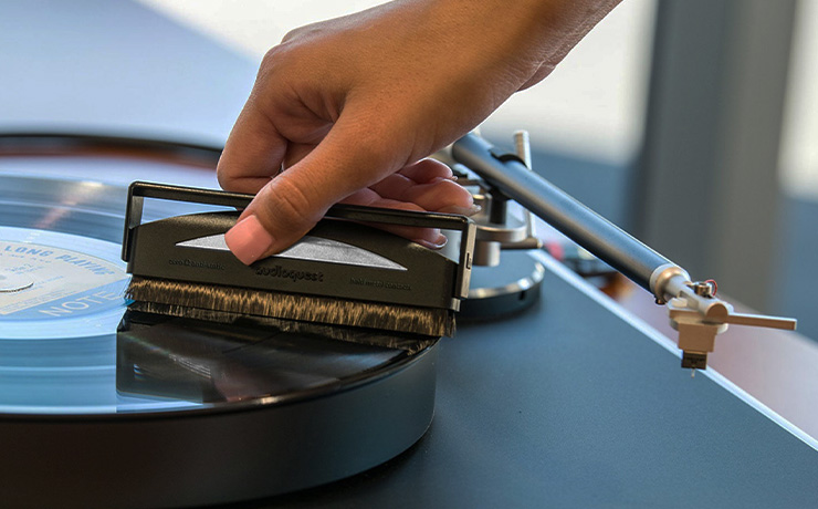 The AudioQuest record brush being used on a record on a turntable.