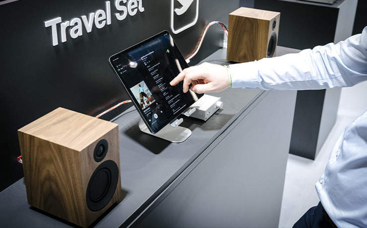 A pair of walnut Project Speaker Box 3 E Carbon speakers on a unit with an iPad in between them both