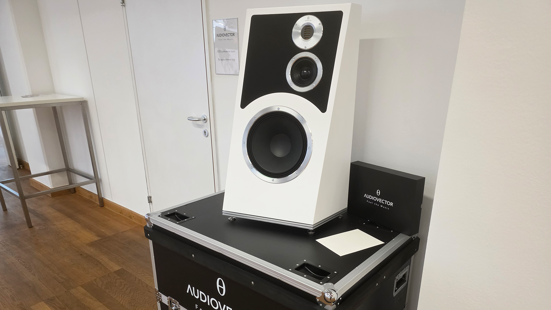 The Audiovector Trapeze speaker on top of a large speaker case