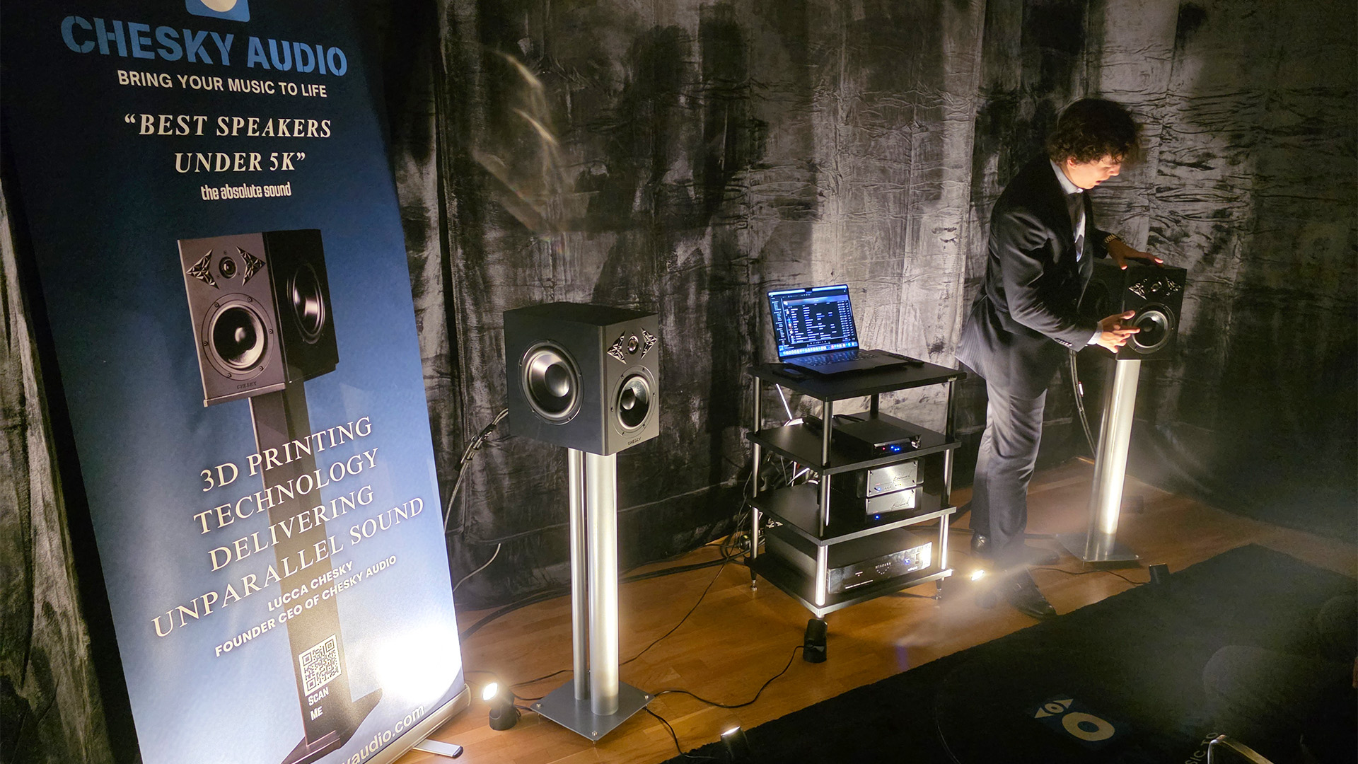 The Chesky Audio room.  A man is stood beside a speaker talking about it