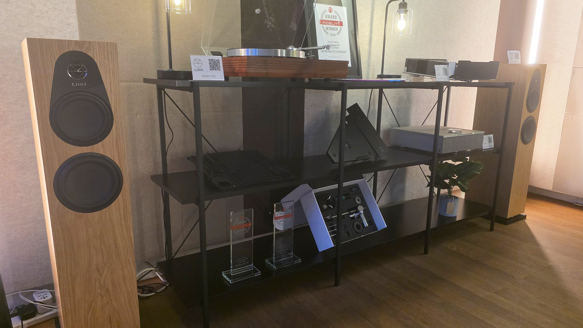 A pair of Linn 150 speakers with various Linn products on a rack in between