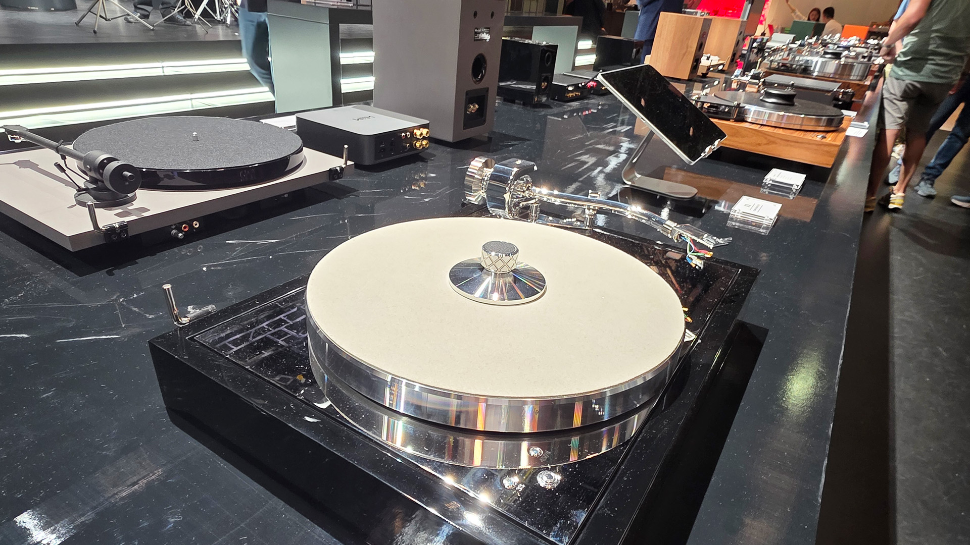 Project turntables with record pucks on the top of the vinyl