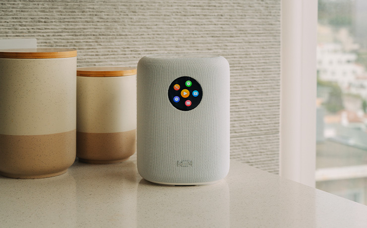 A white WiiM Sound speaker in a kitchen