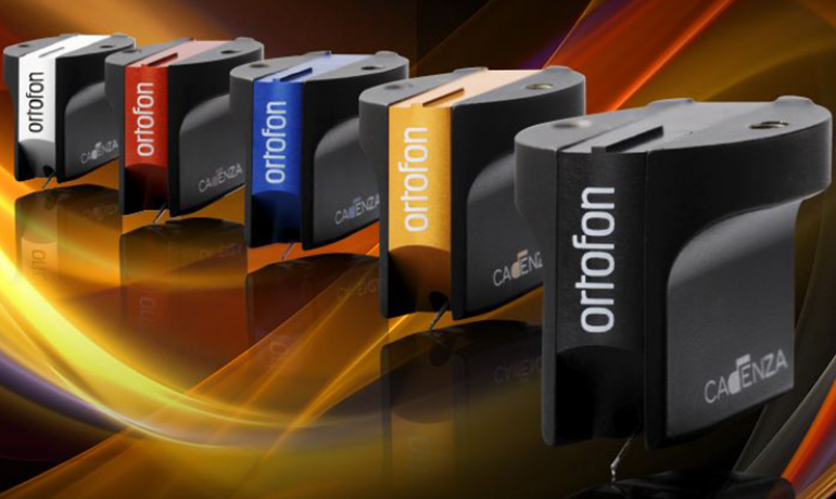 Ortofon Cadenza Cartridges lined up beside each other: Mono, red, blue, bronze, black on an amber and black swirly background.