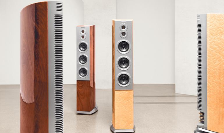 Four Audiovector R10 Arrete speakers in a large, open space