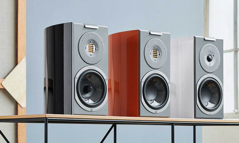 Three R1 speakers lined up on a shelf