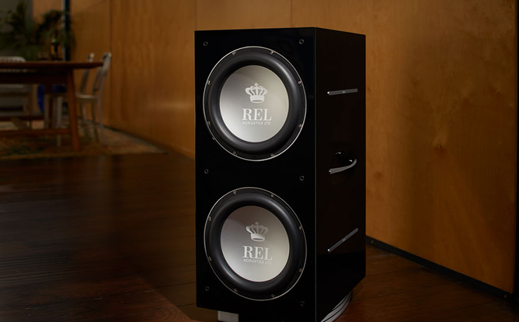 REL 212/SX Subwoofer in a sparse brown living area