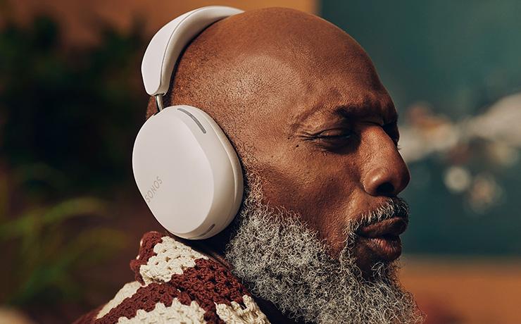 Sonos Ace Headphones in white being worn by a man who is facing to the right of the image.