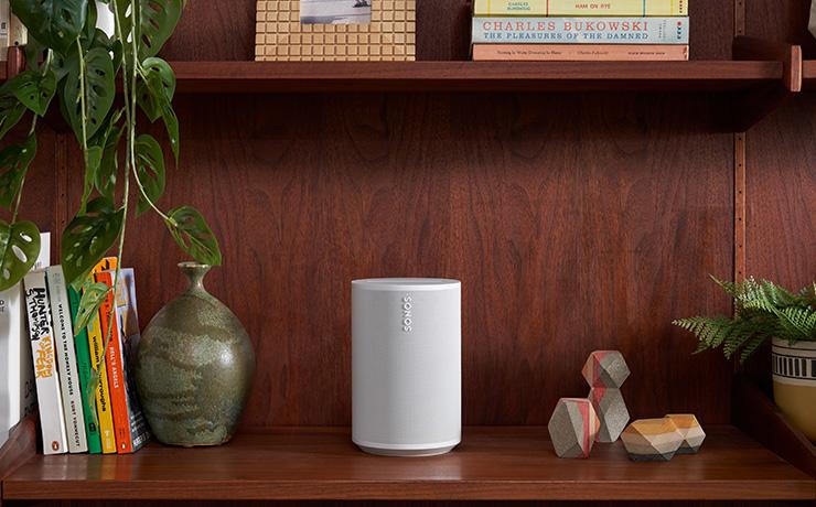 SONOS Era 100 Loudspeaker on a side unit with a vase on one side