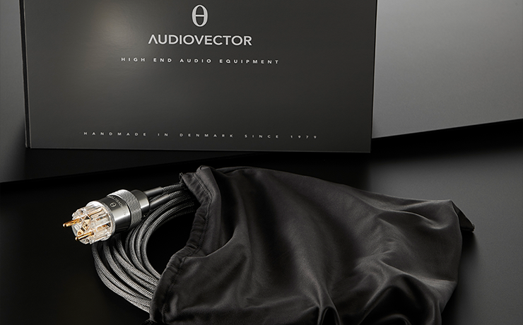 Audiovector Freedom Concept for R Centre coiled and partially in a cloth bag.  A sign behind says "Audiovector high end audio equipment"
