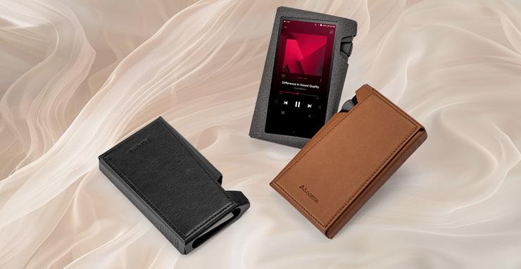 Three Astell & Kern SR35 Cases with music players in them.  Two face-down and one face-up