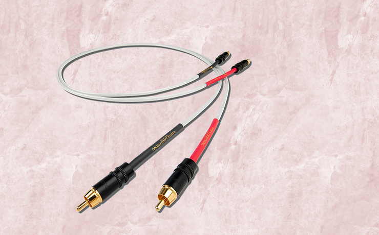 Nordost White Lightning Analogue Interconnect.  Background is a salmon marble pattern.