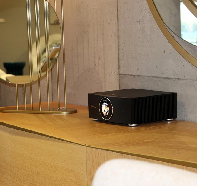 Cabasse Abyss Stereo Amplifier on a sideboard with mirrors on the wall behind.