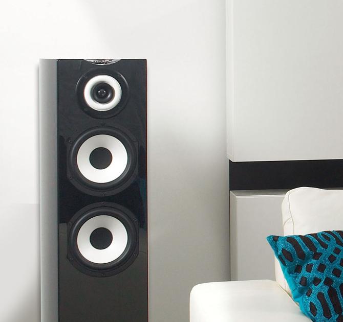 Cabasse Java MC40 Loudspeaker in black beside a white sofa