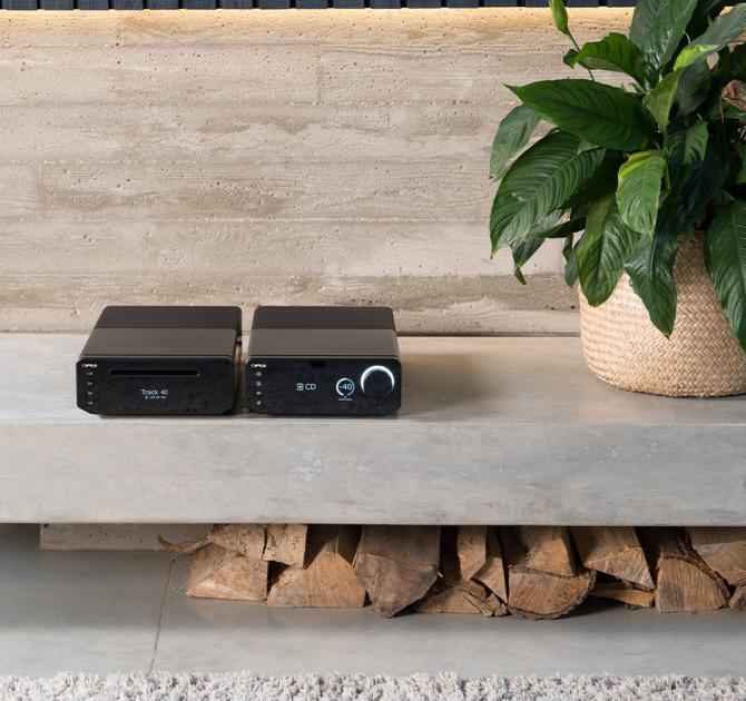 Cyrus 40 AMP - Integrated Amplifier on a shelf with a plant beside it and another Cyrus unit