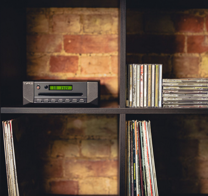 Cyrus CD i Integrated CD Player and DAC in a modular shelving unit with records and CDs.
