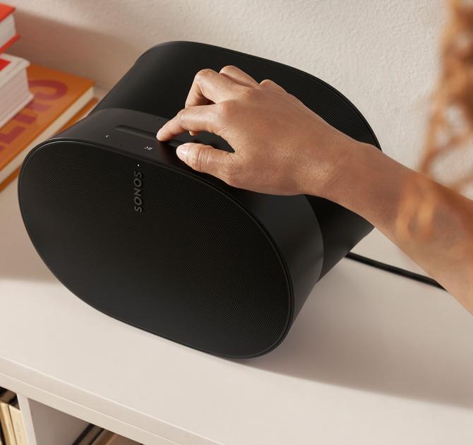 SONOS Era 300 Loudspeaker with a person's hand touching the controls
