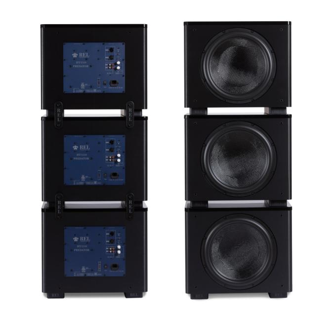 Six REL HT/1510 Predator Subwoofers stacked in two groups of three.  one viewed from the front, one from the back