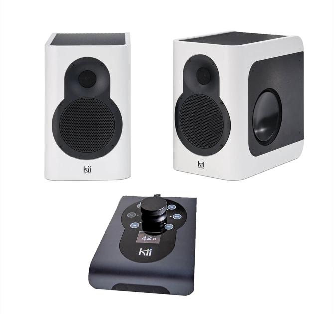 A pair of Kii Seven speakers in white with a black Kii control