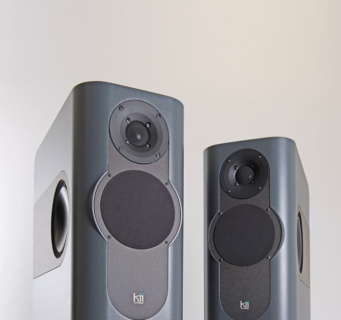 A pair of Kii Three Loudspeakers in mid-grey