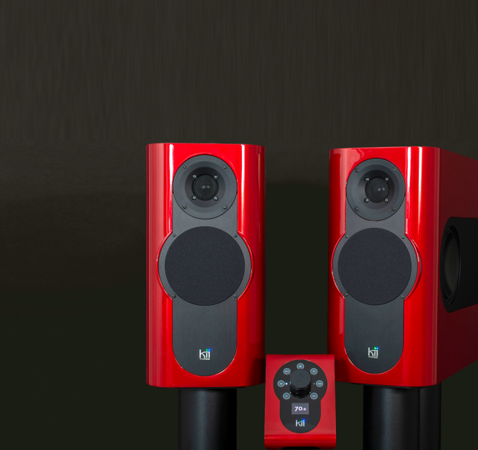 A pair of Kii Three Loudspeakers in gloss red with matching Kii Controller