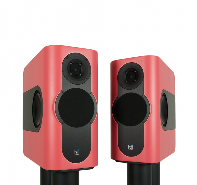 A pair of Kii Three Loudspeakers in a satin salmon colour
