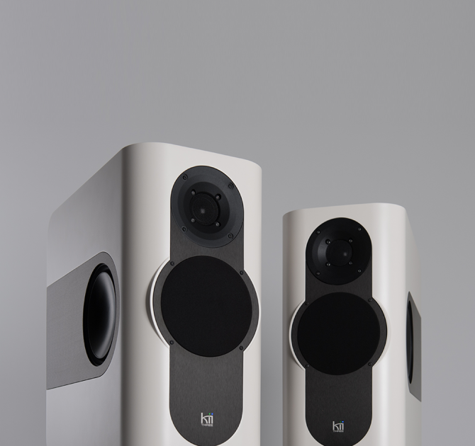 A pair of Kii Three Loudspeakers in matt white
