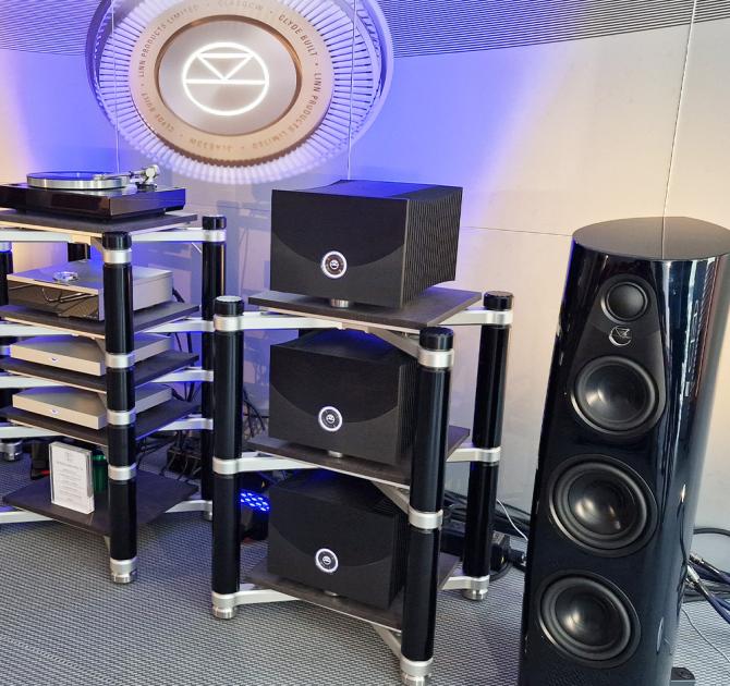 Linn Klimax Solo 800 Power Amplifiers - 3 of them on shelves one above the other.  Other HiFi equipment is to the left and the floorstanding 360 speakers are on the right