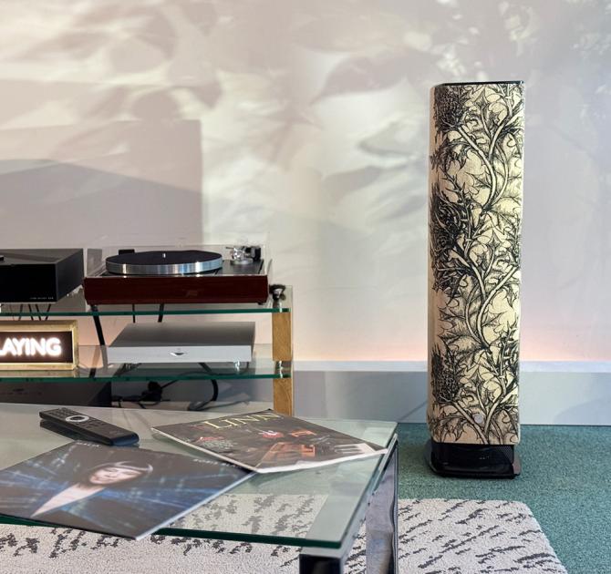 A Linn Series 5 530 Loudspeaker in thistle in the ripcaster showroom with pieces of HiFi equipment to the left of the image next to the speaker