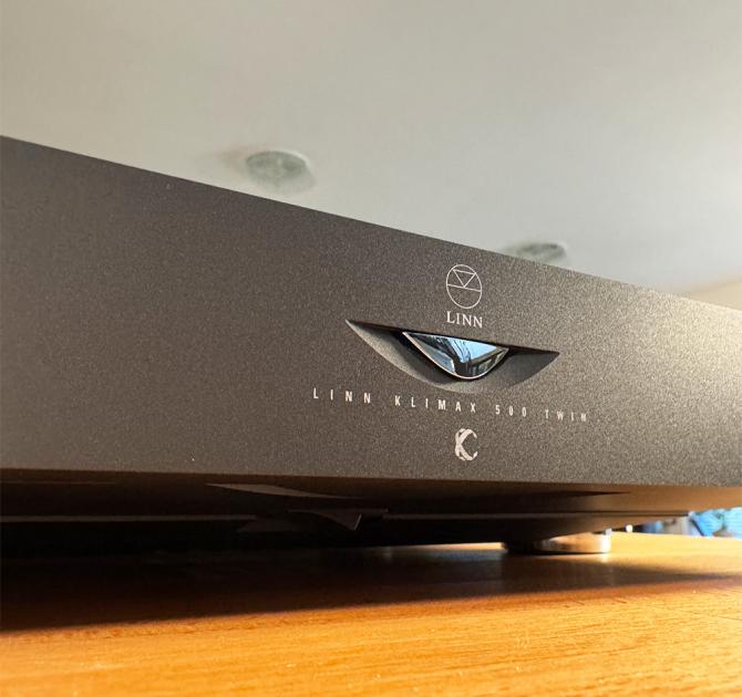 Linn Klimax Twin Amplifier in black - close-up of the front.  The Amp is sitting on a wooden surface in the ripcaster showroom